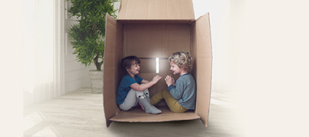 Kids playing in a cardboard box